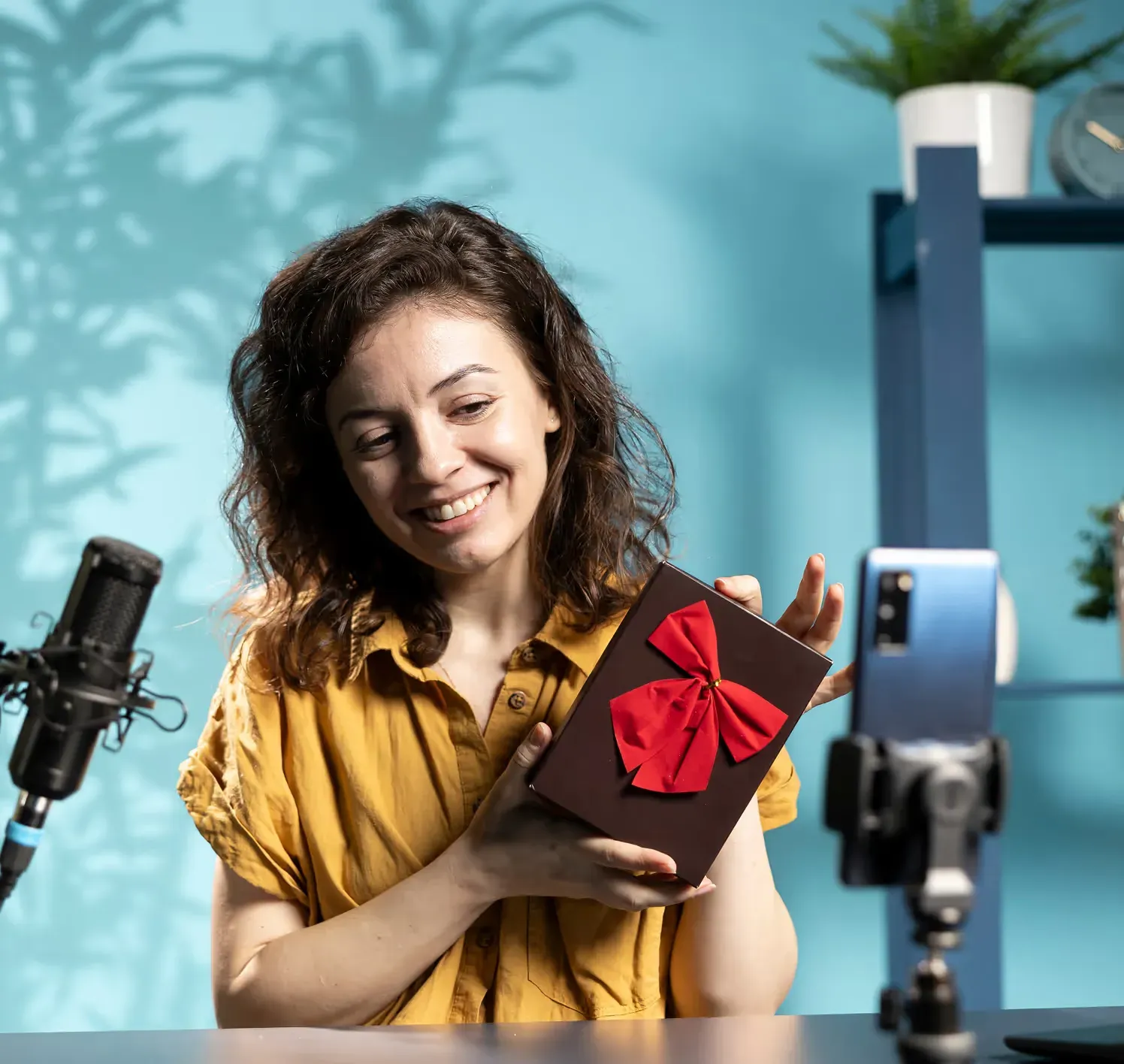 A creator holding up a product to her camera