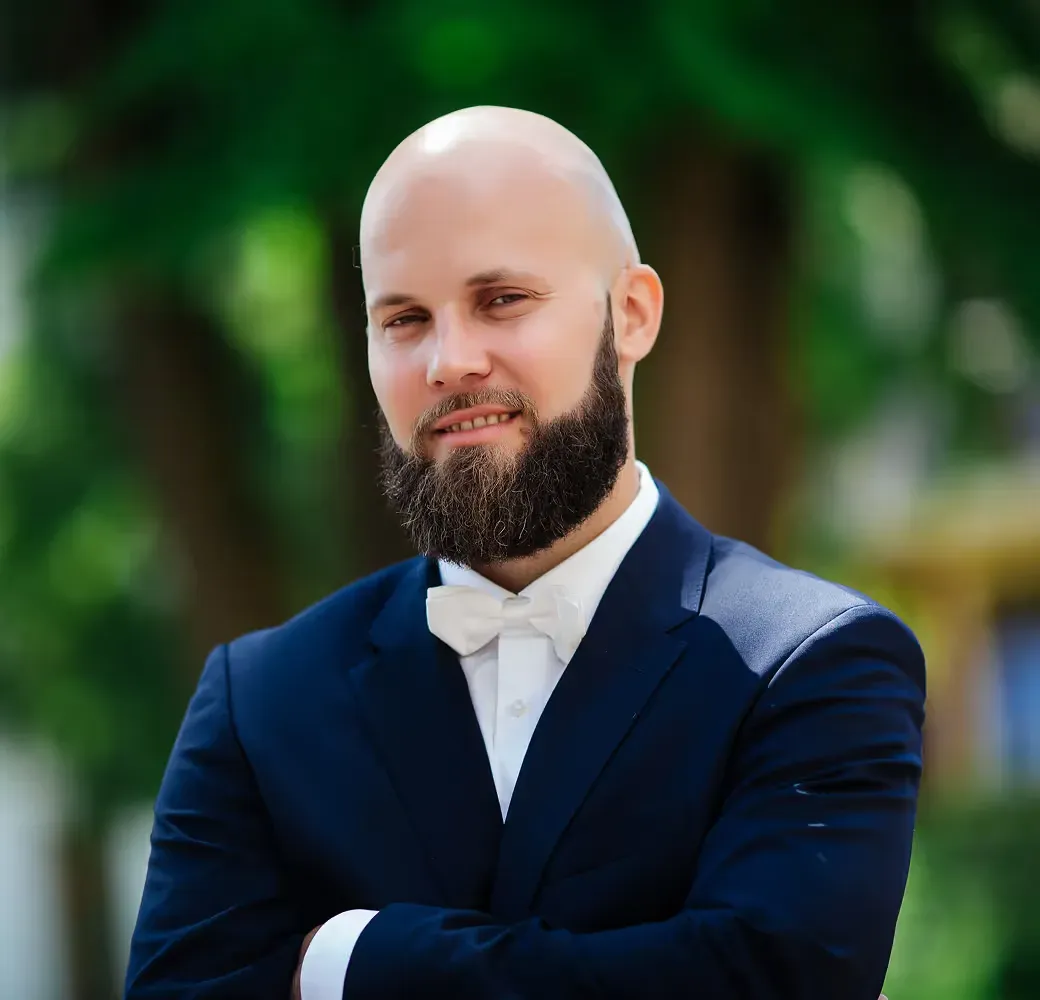 James Miller, a bearded man in a navy suit and bow tie