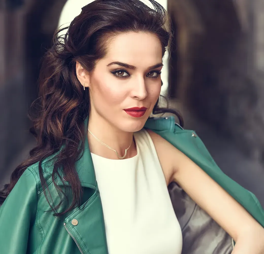Olivia Davis, a woman with dark hair in a green leather jacket